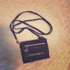 Small black shoulder wallet with detachable strap.